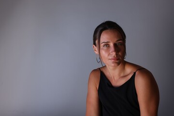 Fototapeta premium Portrait of beautiful woman on grey background. Space for text