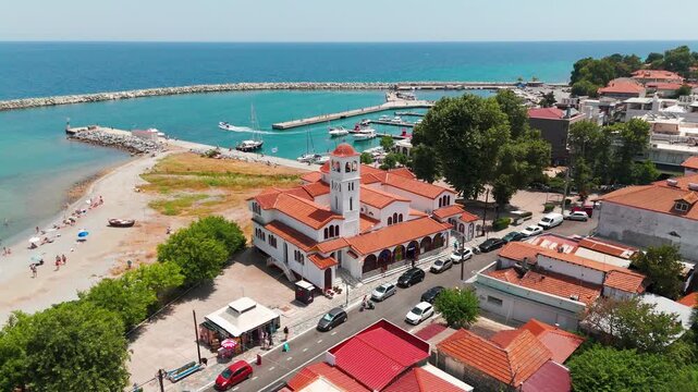 Aerial Drone Shot Flying Over Turquoise Aegean Sea Towards Platamon Coastal Town, Pieria, Greece On A Sunny Summer Afternoon.