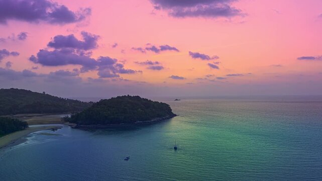 aerial hyperlapse view colorful sky of sunset above Kala island at Layan beach Phuket.
video 4K. Nature video High quality footage. 
Scene of Colorful romantic sky in sunset with cloud 