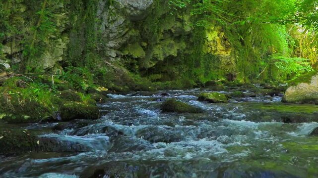 A 20-second still video of the Aude River in the Axat Valley. Water flows among rocks with small waterfalls in the forests of southern France.