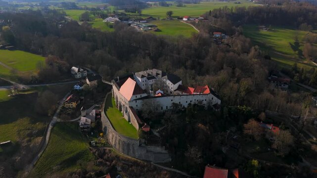Aerial view of Tittmoning Castle, historic medieval fortress located in Traunstein district of Bavaria, Germany. Scenic landscapes, stone walls, cultural heritage site. Luftaufnahme Burg Tittmoning. 
