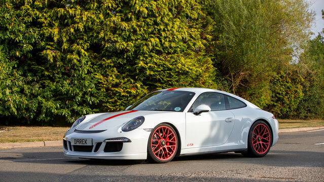 Whittlebury,Norhants,UK - Aug 23rd 2025:  2014 white Porsche 911 Carrera gts  car driving on a British road