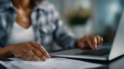 Person typing an invoice on a laptop while working from home