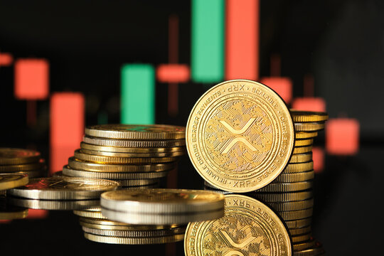 XRP cryptocurrency coins stacked against a digital trading chart background