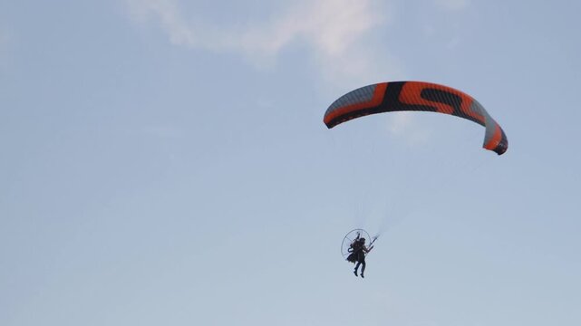 A breathtaking and thrilling display of paramotoring takes place amidst a stunning and picturesque sky