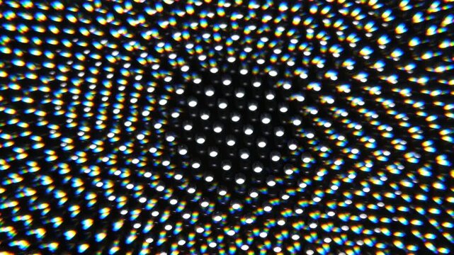 Drehende bewegliche Symmetrische Lichtpunkt Musterung vor einem schwarzen Hintergrund, Kaleidoskopischer geometrisches Lichter Spektrum von  einem drehenden LED Panel 