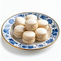 Obraz premium Delicate vanilla macarons arranged elegantly on a floral patterned plate on white background