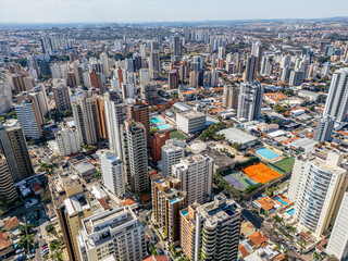 Imagem aérea dos bairros Centro e Cambuí. Prédios comerciais e ruas com muito tráfego de carros e ônibus.