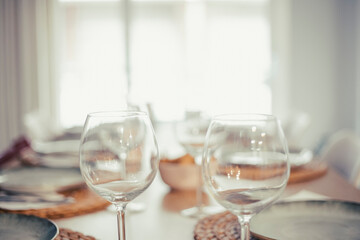 Empty wineglasses on an empty table full of cutlery and tableware before a party