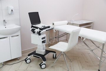 Modern ultrasound machine and examination bed in clinic
