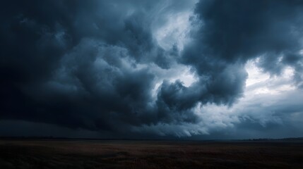 Dramatic storm clouds gathering over rural farmland
