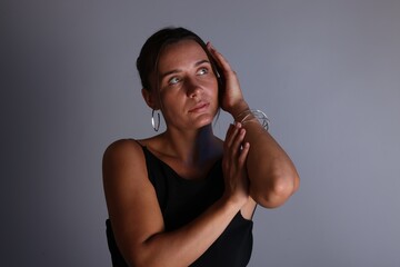 Beautiful woman with bracelet on grey background