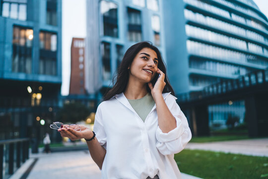 Thoughtful young woman holds digital tablet, symbolizing focus, digital research, remote productivity and modern tech-centered thinking in connected lifestyle. - Powered by Adobe