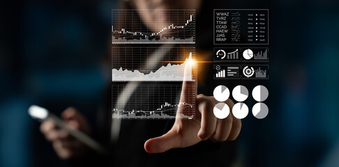 A businessperson interacts with a virtual screen displaying various financial charts, emphasizing data analysis and technology in a modern office environment. Impute