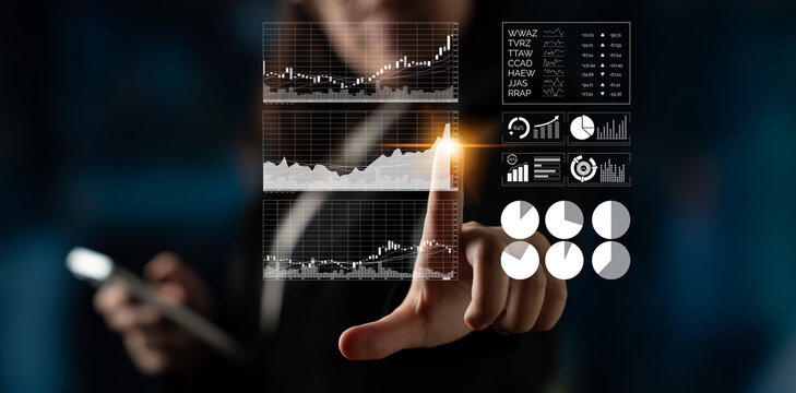 A businessperson interacts with a virtual screen displaying various financial charts, emphasizing data analysis and technology in a modern office environment. Impute - Powered by Adobe
