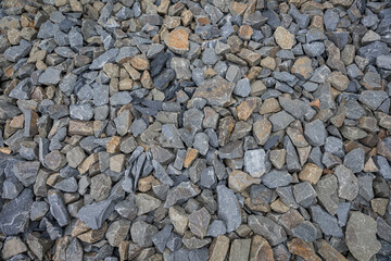 Close-up of broken stones piled up, about fist-sized.
