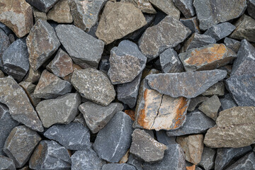 Close-up of broken stones piled up, about fist-sized.
