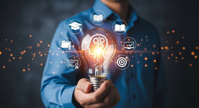 Man holding a light bulb with education and business icons around it