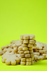 a short stack of star-shaped cookies surrounded by others, all on a bright yellow-green background