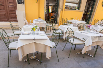 Empty outdoor seating at a traditional greek restaurant in corfu.