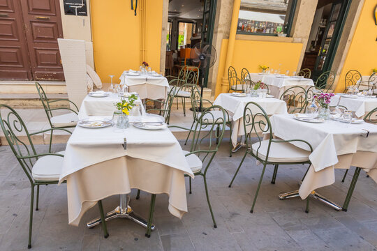 Fototapeta Empty outdoor seating at a traditional greek restaurant in corfu.
