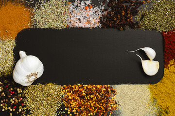 Frame made with different spices on dark background, flat lay. Space for text