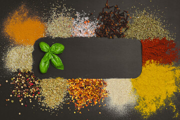 Frame made with different spices on dark background, flat lay. Space for text