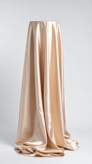 Elegant Golden Satin Fabric Drape Displayed on a Pedestal in Studio with Soft Lighting