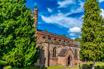 A view towards the side of the Church of St Chad at the end of Stowe pool in Lichfield, UK in...
