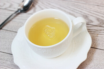 Herbal linden tea in a mug on a wooden table