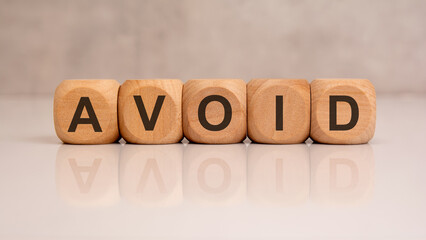 Wooden block with text avoid.