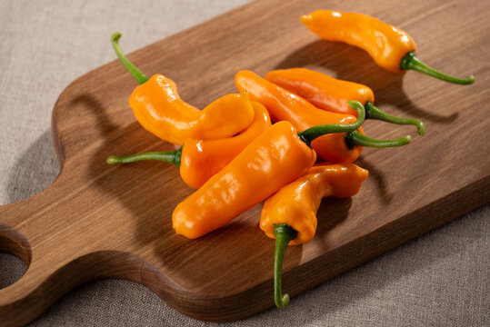 Yellow Orange Datil Peppers on Wooden Kitchen Board