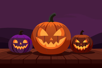 Three carved halloween pumpkins glow on a wooden surface