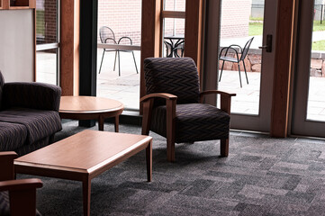 Modern Lounge Area with Comfortable Seating and Large Windows Overlooking Patio