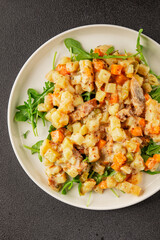 Potato salad with smoked fish tasty snack fresh delicious gourmet food background on the table rustic food top view copy space