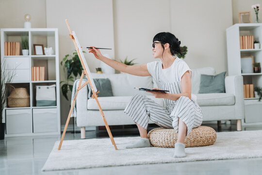 Japanese mature female artist prepare palette and brush for painting on canvas - Powered by Adobe