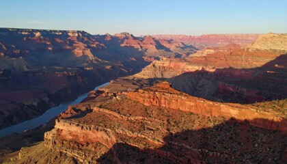 Aerial view of the sunlit Grand Canyon highlighting geological formations and natural beauty