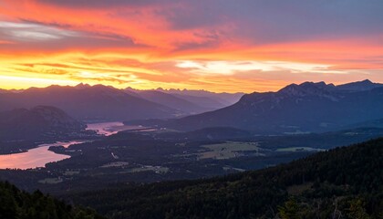 A Breathtaking Sunset Over Majestic Mountains And A Serene Valley Landscape