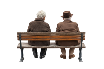 Senior couple sitting peacefully on park bench, wearing winter clothing and looking at camera