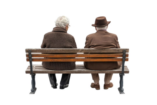Senior couple sitting peacefully on park bench, wearing winter clothing and looking at camera