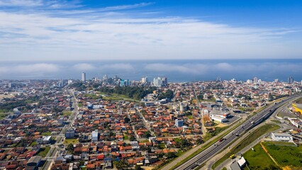 Fototapeta premium Aerial cityscape of Barra Velha with BR-101 highway and coastline view.