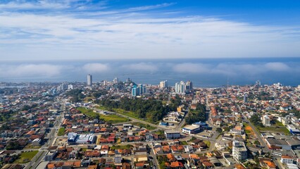 Obraz premium Panoramic aerial view of Barra Velha city with low mist over the coast.