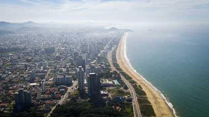 Fototapeta premium Aerial view of Balneário Piçarras coastline with full beachfront and cityscape.