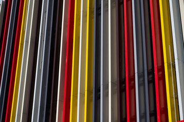 Vertical multi-colored stripes in the design of a shop window fragment.