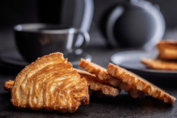 Le sfoglie. Crispy sweet pastry on black table.