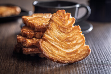 Le sfoglie. Crispy sweet pastry on wooden table.
