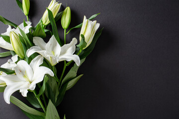 Elegant bouquet of white lilies on dark background. of Mourning, funeral, sympathy concept © photoguns