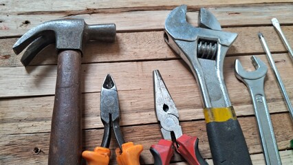 Assortment of Hand Tools for Construction and Repair on Wooden Surface