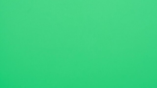 Stop motion animation of crumpled pape on a green background