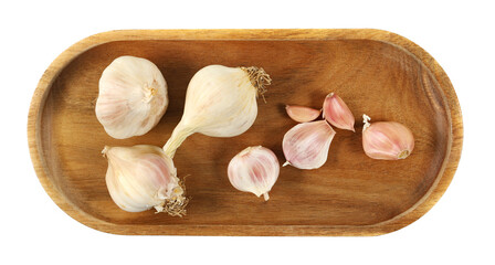 Garlic in oval wooden plate isolated on white background, top view